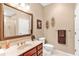 Bathroom featuring a glass-enclosed shower, cherry vanity, and decorative wall accents at 220 Nautica Mile Dr, Clermont, FL 34711