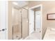 Bathroom showcasing a modern glass shower, neutral tiles, and access to the Primary at 220 Nautica Mile Dr, Clermont, FL 34711