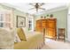 Charming bedroom showcasing a ceiling fan, large windows, and a wooden wardrobe at 220 Nautica Mile Dr, Clermont, FL 34711