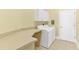 A well-equipped laundry room featuring a side-by-side washer and dryer, and counter space for folding and organizing at 220 Nautica Mile Dr, Clermont, FL 34711