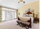 Vaulted ceilings highlight the suite, featuring french doors to a private balcony, and offering plenty of natural light at 220 Nautica Mile Dr, Clermont, FL 34711