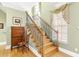 Elegant staircase features hardwood steps, wrought iron railings, and decorative window treatments, enhancing the foyer at 220 Nautica Mile Dr, Clermont, FL 34711