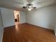 Spacious bedroom features wood-look floors, ceiling fan, and closet at 2309 Fairview Ct, Eustis, FL 32726