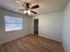 Bedroom featuring wood-look floors, a window, a closet, and a ceiling fan at 2309 Fairview Ct, Eustis, FL 32726