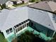 Aerial view showcasing a gray roof, screened-in lanai, and a private backyard, perfect for outdoor living at 25517 Laurel Valley Rd, Leesburg, FL 34748