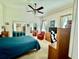 Bright bedroom with ceiling fan, mirror closet doors, and soft natural light at 25517 Laurel Valley Rd, Leesburg, FL 34748