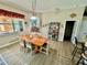 Charming dining room with a wooden table, natural light, and an adjacent view of a sunroom at 25517 Laurel Valley Rd, Leesburg, FL 34748