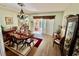 Formal dining room featuring wood floors, elegant lighting, and access to the porch at 25517 Laurel Valley Rd, Leesburg, FL 34748