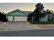 Charming home featuring a two-car garage, a well-manicured lawn, and a screened in porch at 25517 Laurel Valley Rd, Leesburg, FL 34748