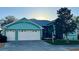 Lovely home featuring an attached two-car garage and a screened-in front porch area at 25517 Laurel Valley Rd, Leesburg, FL 34748