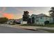 Street view of a well-maintained single story home with a lush lawn, two-car garage and mature landscaping at 25517 Laurel Valley Rd, Leesburg, FL 34748