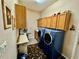 Laundry room with front load washer and dryer and upper and lower cabinets at 25517 Laurel Valley Rd, Leesburg, FL 34748