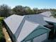 Aerial view of the home's new gray roof and well-maintained light blue exterior at 25517 Laurel Valley Rd, Leesburg, FL 34748