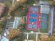 Aerial view of multi-colored tennis courts and facilities at 25517 Laurel Valley Rd, Leesburg, FL 34748