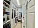 Spacious walk-in closet with custom cabinetry, shelving, drawers, and a vanity mirror at 25517 Laurel Valley Rd, Leesburg, FL 34748