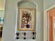 Charming wall nook featuring an elegant framed floral artwork and decorative candle holders at 25517 Laurel Valley Rd, Leesburg, FL 34748