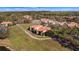 Aerial view of the home and surrounding area, highlighting lush landscaping and community features at 26207 Avenida Las Colinas # 13A, Howey In The Hills, FL 34737