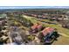 Aerial view of a property with red tile roof, pond, and golf course at 26207 Avenida Las Colinas # 13A, Howey In The Hills, FL 34737