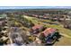 Aerial view of a property with red tile roof, pond, and golf course at 26207 Avenida Las Colinas # 13A, Howey In The Hills, FL 34737