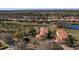 Aerial view of home featuring a tile roof and backing onto a serene pond in a desirable neighborhood at 26207 Avenida Las Colinas # 13A, Howey In The Hills, FL 34737