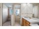 Bright bathroom features a glass-enclosed shower, a toilet, and wooden cabinets topped with a pristine white counter at 26207 Avenida Las Colinas # 13A, Howey In The Hills, FL 34737