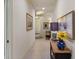 Bright hallway featuring neutral walls, tiled flooring, decorative paintings, and offering a glimpse into other rooms at 26207 Avenida Las Colinas # 13A, Howey In The Hills, FL 34737