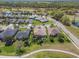 Picturesque aerial view showcasing houses with lush greenery and nearby golf course at 26694 Otter Creek Ln, Leesburg, FL 34748