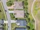 Aerial view of the home featuring a screened in patio, manicured lawn, and nearby golf course at 26694 Otter Creek Ln, Leesburg, FL 34748