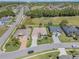 Wide aerial shot of a neighborhood featuring well-kept lawns, mature trees, and proximity to a golf course at 26694 Otter Creek Ln, Leesburg, FL 34748