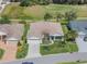 Aerial view of a home with well-manicured landscaping and a golf course in the background at 26694 Otter Creek Ln, Leesburg, FL 34748