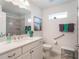 Bright bathroom featuring a vanity with a modern faucet and a tiled shower at 26694 Otter Creek Ln, Leesburg, FL 34748