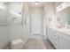 Bright bathroom featuring a double vanity, a walk-in shower and tile flooring at 26694 Otter Creek Ln, Leesburg, FL 34748