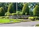 Entrance sign for Arlington Ridge, surrounded by manicured landscaping at 26694 Otter Creek Ln, Leesburg, FL 34748