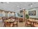 A beautifully decorated dining room with a fireplace and large windows, perfect for entertaining guests at 26694 Otter Creek Ln, Leesburg, FL 34748