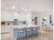 Bright, modern kitchen with white cabinets, large island with seating, and pendant lighting, creating an elegant and functional space at 26694 Otter Creek Ln, Leesburg, FL 34748