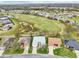 This aerial shows the property in relation to a golf course, adjacent pond, and surrounding homes at 26821 Augusta Springs Cir, Leesburg, FL 34748