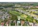 Enjoy this lovely home from above, surrounded by lush landscaping and a golf course at 26821 Augusta Springs Cir, Leesburg, FL 34748