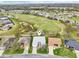 Aerial view of a home on a golf course community surrounded by lush greenery and well-maintained landscaping at 26821 Augusta Springs Cir, Leesburg, FL 34748