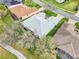 Aerial view of house showing manicured lawn, mature trees and a sidewalk for a relaxing evening walk at 26821 Augusta Springs Cir, Leesburg, FL 34748