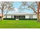 Back of the house with a screened-in lanai, perfect for enjoying the outdoors while staying protected from insects at 26821 Augusta Springs Cir, Leesburg, FL 34748