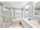 Bright bathroom featuring a double vanity, soaking tub, and glass-enclosed shower at 26821 Augusta Springs Cir, Leesburg, FL 34748