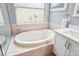 Close up shot of bathroom featuring a large soaking tub with decorative sculptures and a faucet at 26821 Augusta Springs Cir, Leesburg, FL 34748