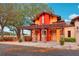 Exterior view of the property, showcasing its colorful facade and pergola-covered entrances at 26821 Augusta Springs Cir, Leesburg, FL 34748