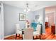 Elegant dining room featuring a glass table, white chairs, and a decorative blue cabinet at 26821 Augusta Springs Cir, Leesburg, FL 34748