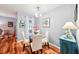 Cozy dining room with a glass table, cream chairs, and stylish decorations in the corner at 26821 Augusta Springs Cir, Leesburg, FL 34748