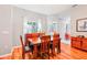 Cozy dining room featuring a wood table, wood chairs, and natural lighting from a window at 26821 Augusta Springs Cir, Leesburg, FL 34748