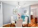 Cozy dining room featuring a modern glass table and four white chairs, perfect for entertaining at 26821 Augusta Springs Cir, Leesburg, FL 34748