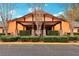 Fairfax Hall entrance with well-kept landscaping, stone pillars and covered entry, and clear signage at 26821 Augusta Springs Cir, Leesburg, FL 34748