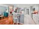 Well-lit kitchen with white cabinets, an island, and a breakfast bar, flowing into a dining area at 26821 Augusta Springs Cir, Leesburg, FL 34748