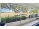 Relax on the lanai with views of the lush greenery and picturesque landscape beyond at 26821 Augusta Springs Cir, Leesburg, FL 34748
